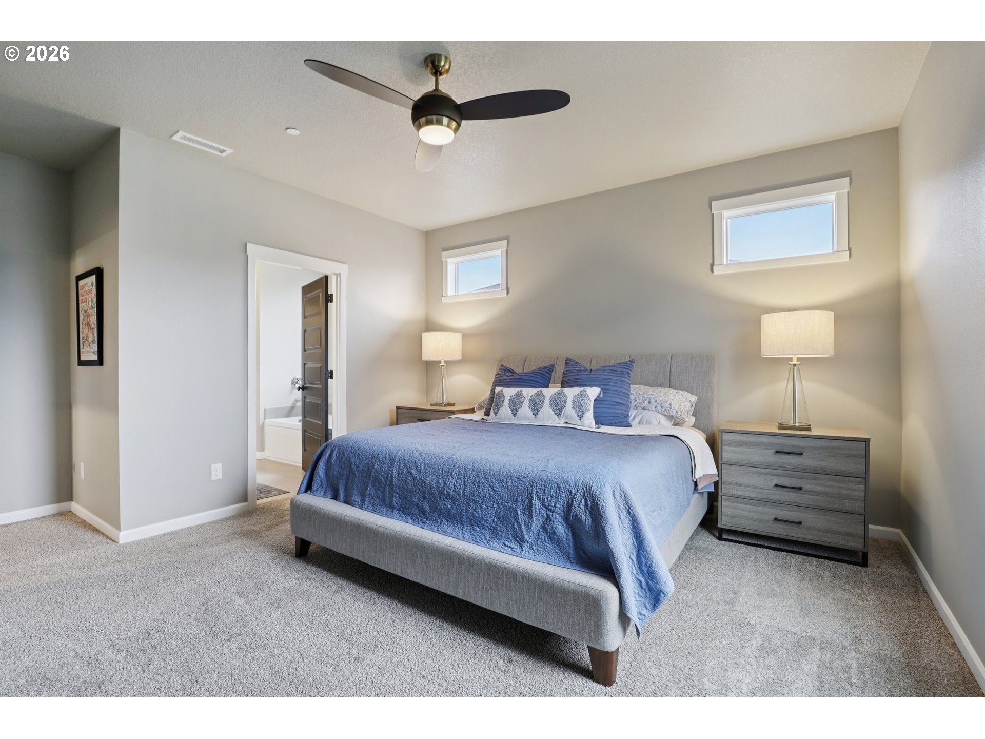 604 Northwest 25th Way Battle Ground, WA 98604 - Photo 17 of 33 a spacious bedroom with a bed and a lamp