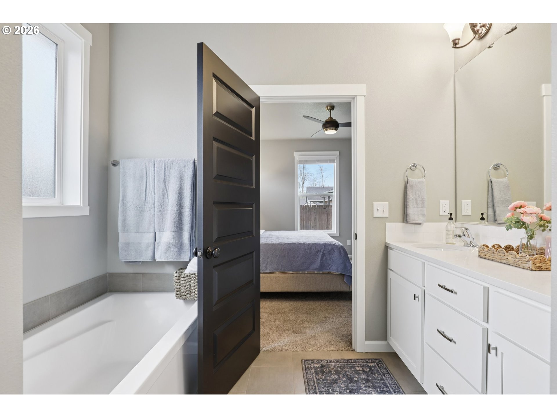 604 Northwest 25th Way Battle Ground, WA 98604 - Photo 20 of 33 a en suite bathroom with a double vanity sink a mirror and a bathtub