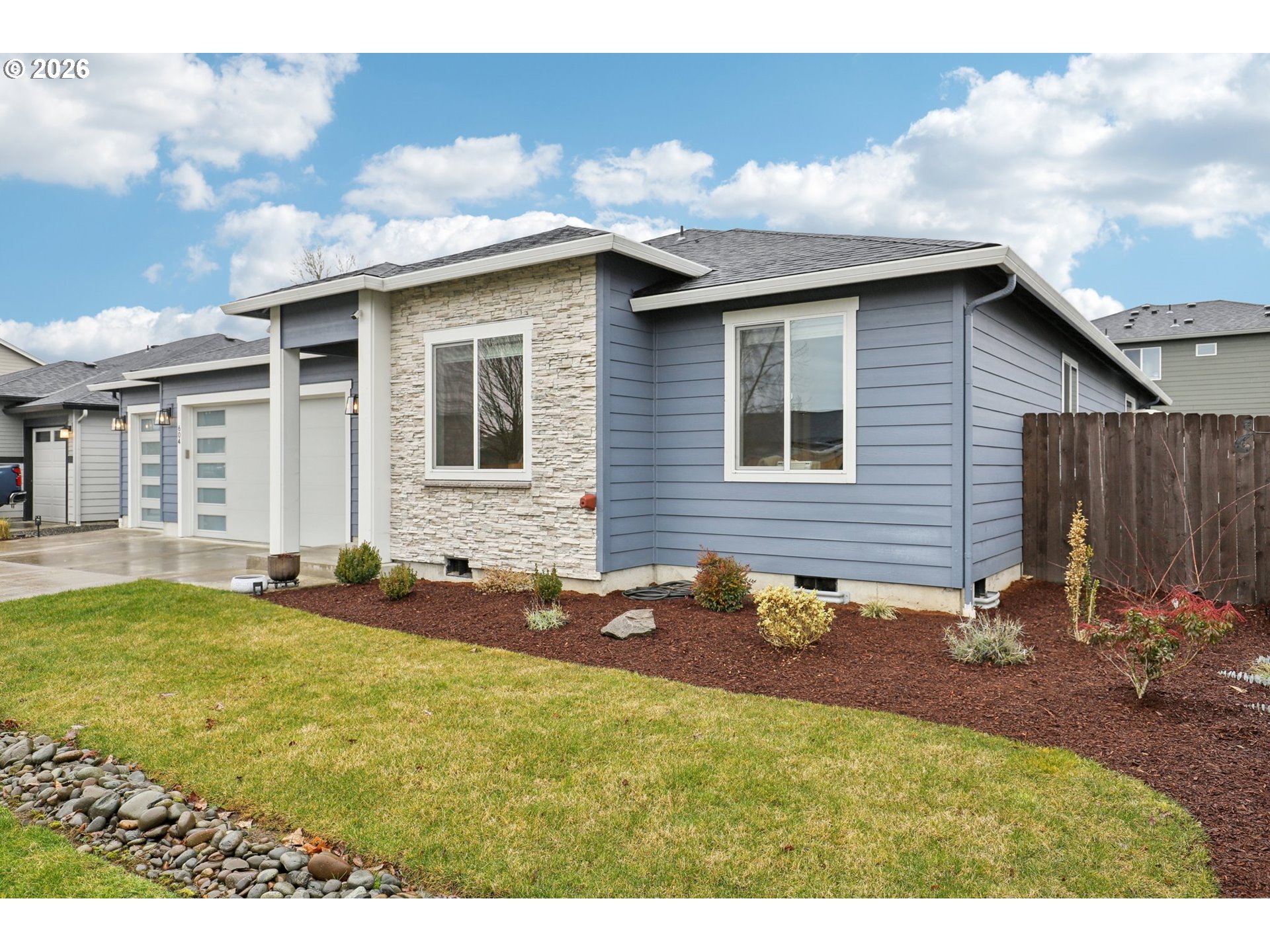 604 Northwest 25th Way Battle Ground, WA 98604 - Photo 2 of 33 a backyard of a house with table and chairs