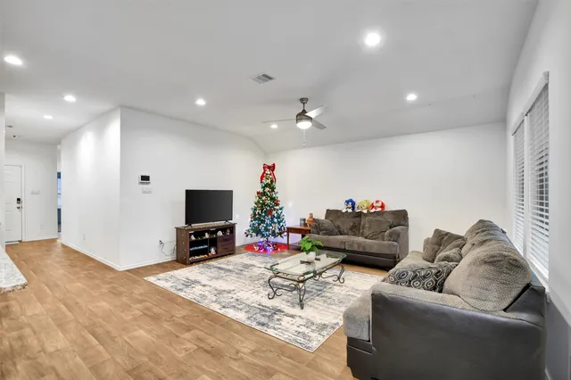 a living room with furniture and kitchen view