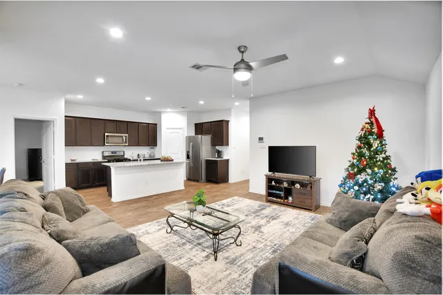 a kitchen with wooden cabinets and stainless steel appliances
