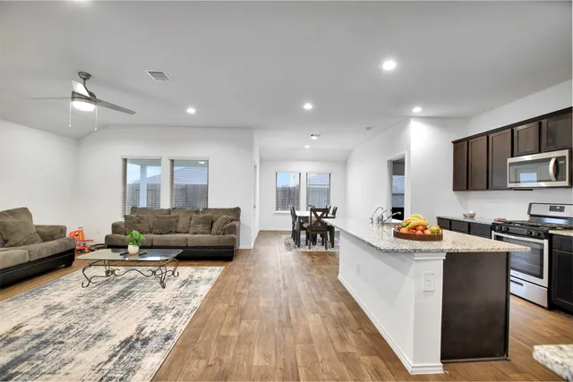 a living room with furniture and a chandelier