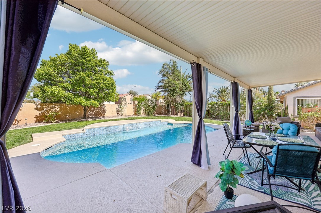 5236 Saranac Road Las Vegas, NV 89130 - Photo 48 of 52 Enjoy outdoor living with a covered patio overlooking the sparkling swimming pool and fenced yard.