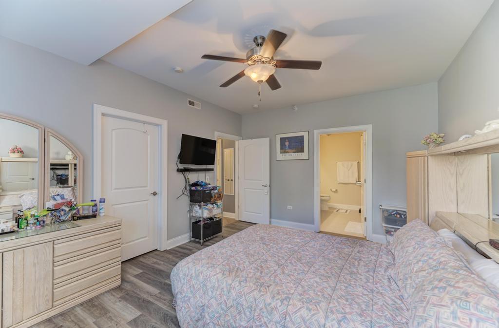 1210 Foxdale Drive, Unit 105 Addison, IL 60101 - Photo 18 of 25 a bedroom with a bed and a large mirror on the dresser