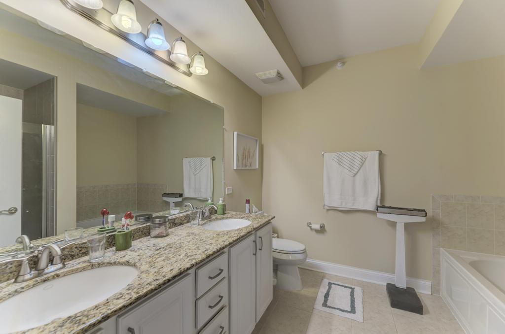 1210 Foxdale Drive, Unit 105 Addison, IL 60101 - Photo 19 of 25 a bathroom with a granite countertop toilet sink and mirror