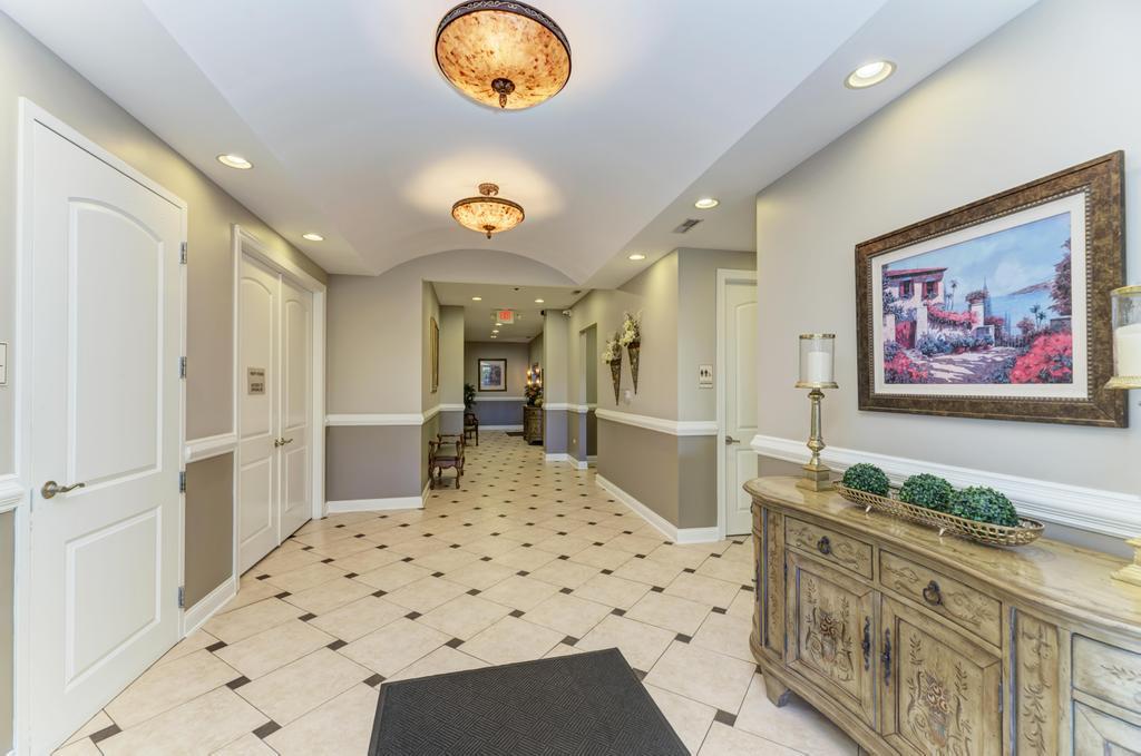 1210 Foxdale Drive, Unit 105 Addison, IL 60101 - Photo 2 of 25 a spacious bathroom with a sink a mirror and a shower