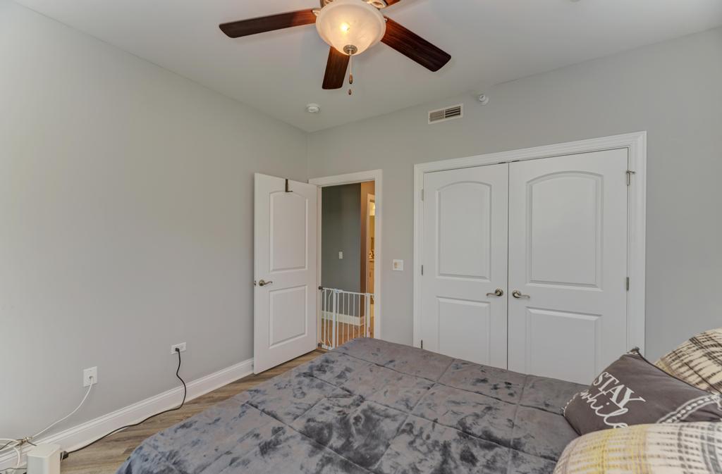 1210 Foxdale Drive, Unit 105 Addison, IL 60101 - Photo 22 of 25 a bedroom with a bed and a chandelier