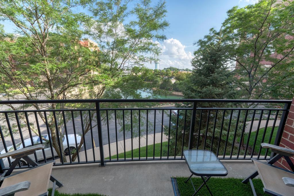 1210 Foxdale Drive, Unit 105 Addison, IL 60101 - Photo 24 of 25 a balcony with chairs