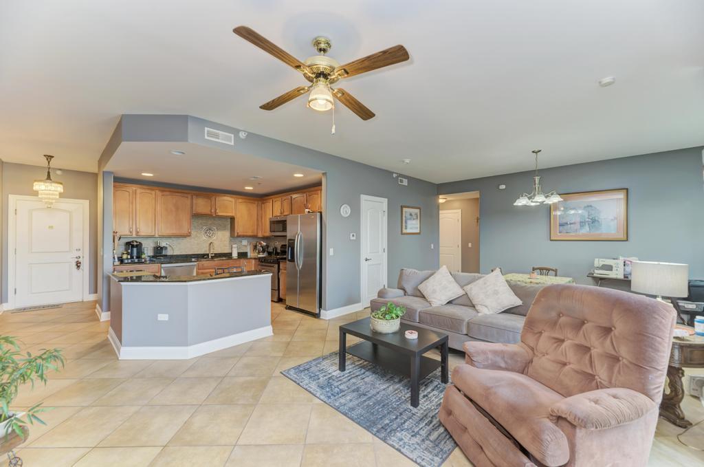 1210 Foxdale Drive, Unit 105 Addison, IL 60101 - Photo 6 of 25 a living room with furniture and kitchen view