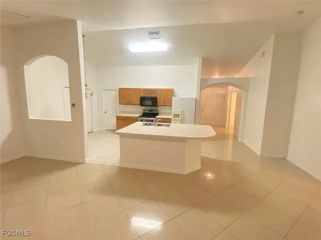 a view of kitchen with stainless steel appliances a sink
