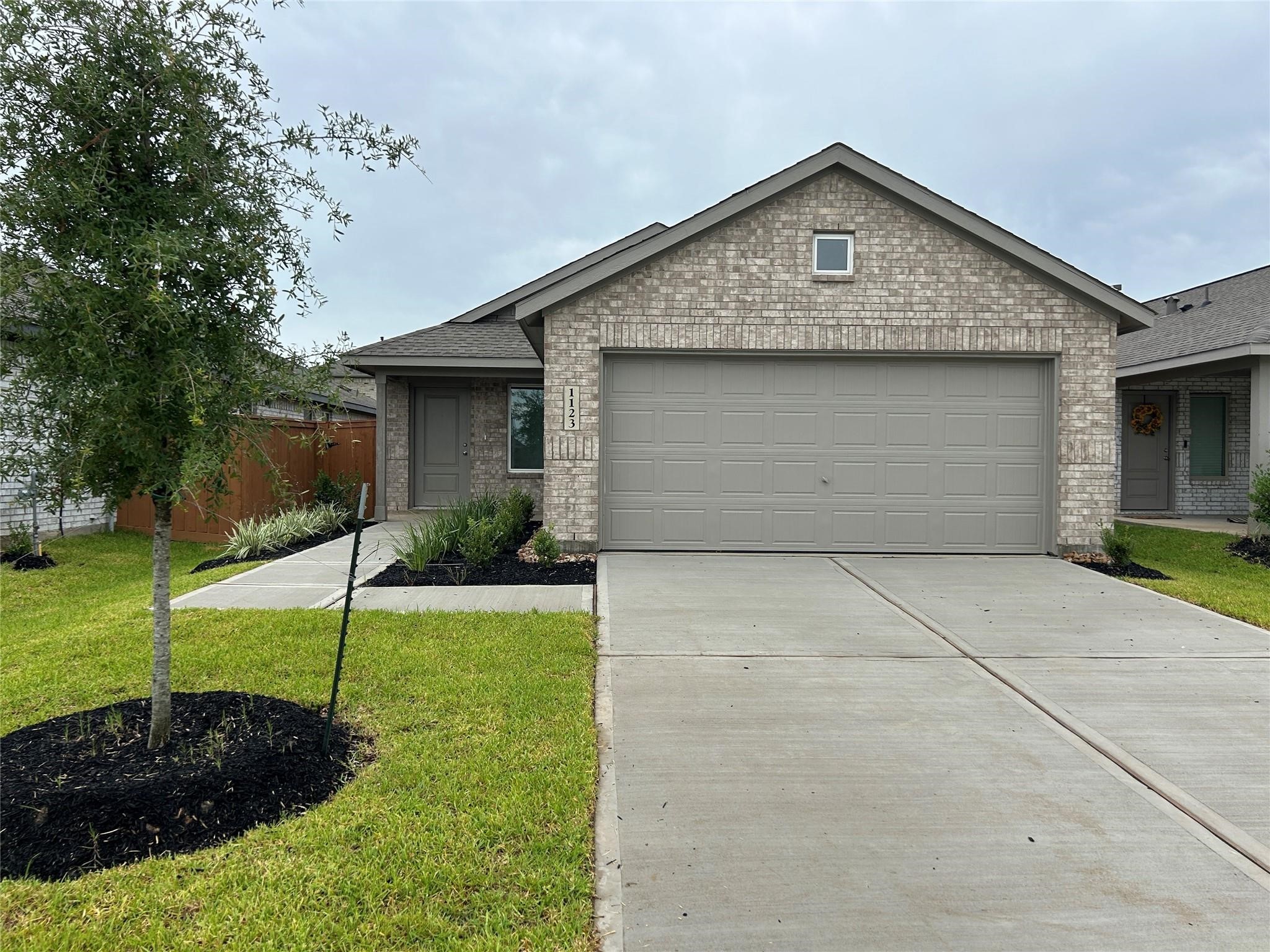 a front view of a house with a yard and a garage