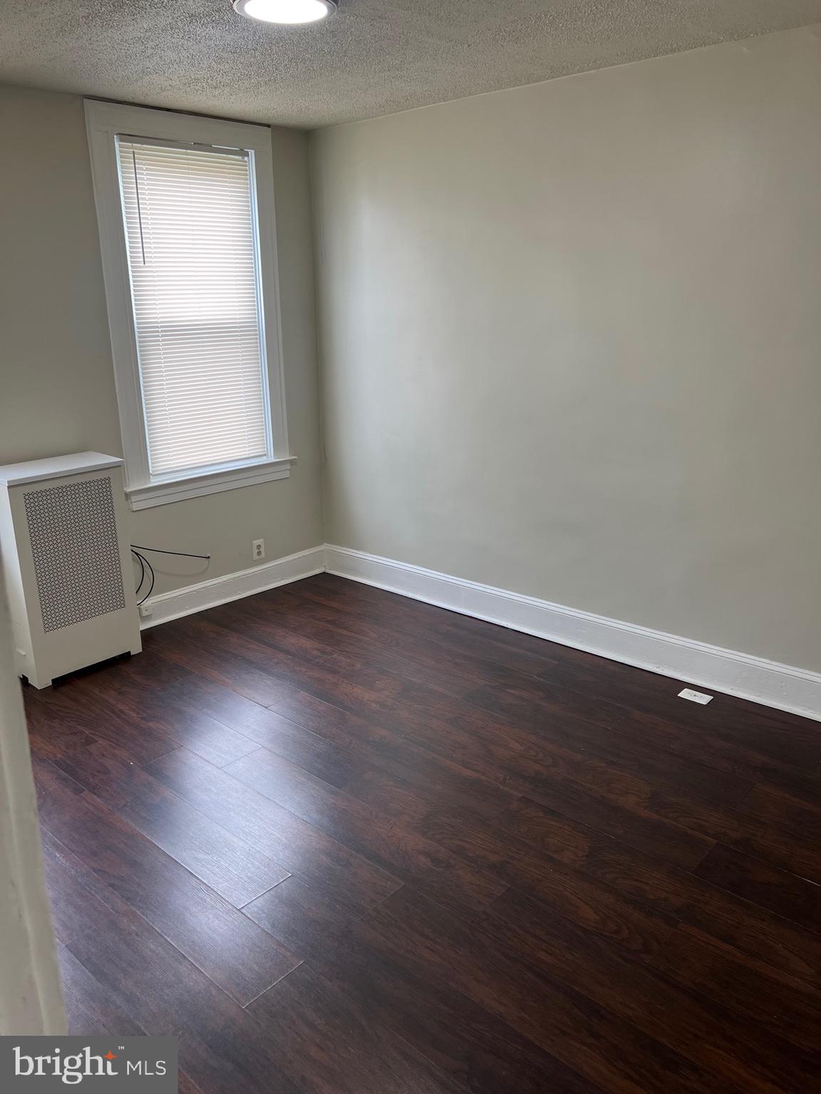 2910 Poplar Terrace Baltimore, MD 21216 - Photo 11 of 14 an empty room with wooden floor and window