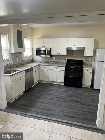 a kitchen with stainless steel appliances granite countertop a sink and stove top oven
