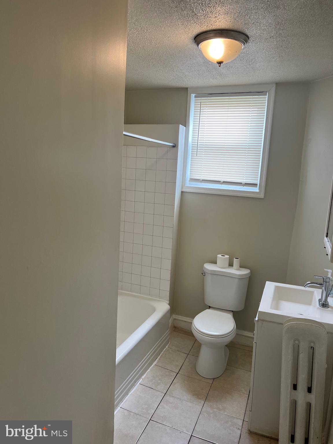 2910 Poplar Terrace Baltimore, MD 21216 - Photo 10 of 14 a bathroom with a toilet sink and mirror