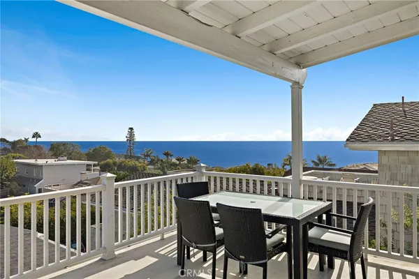 a view of a roof deck with table and chairs