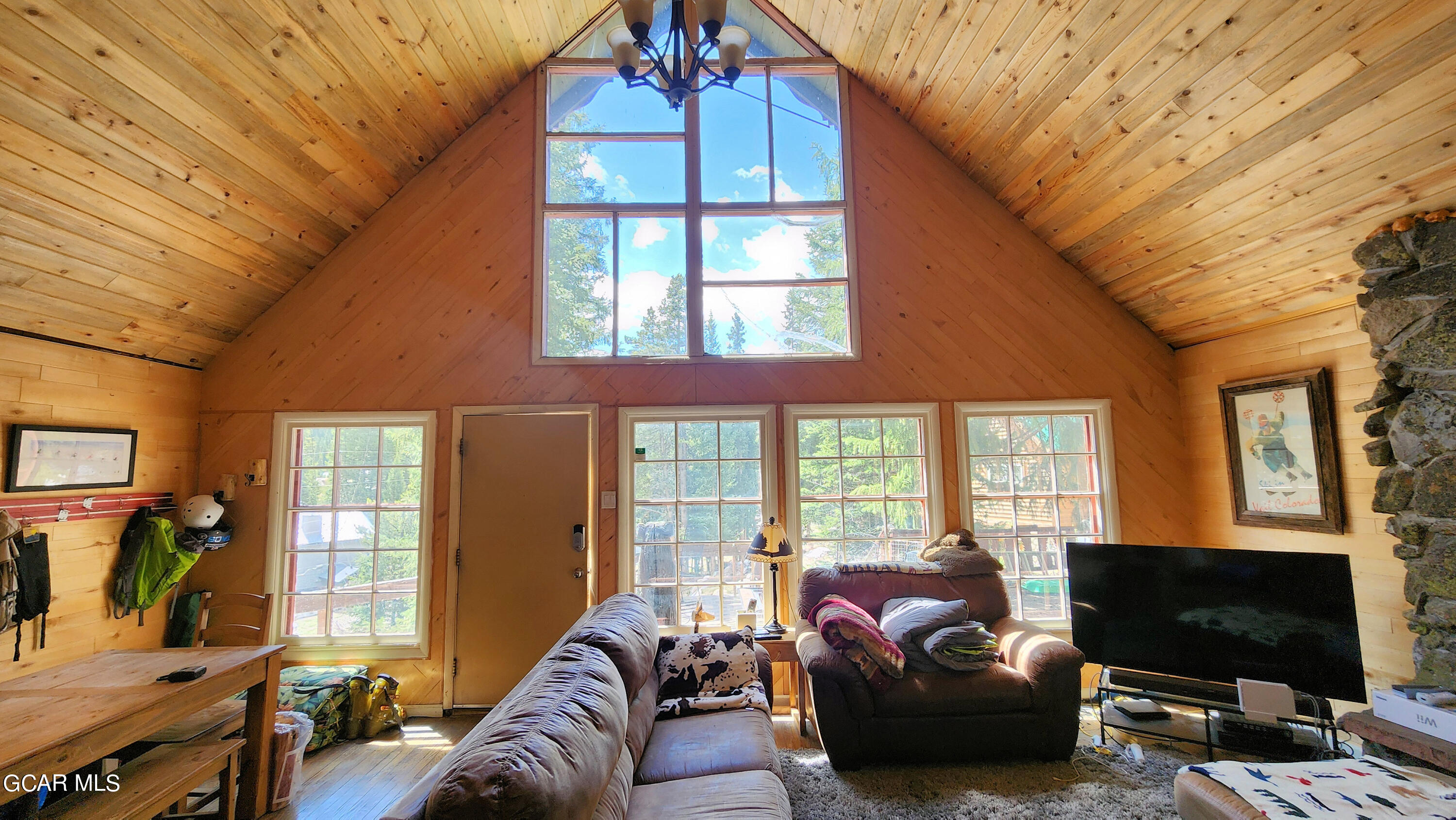573 97 Circle Breckenridge, CO 80424 - Photo 2 of 40 a living room with furniture a flat screen tv and a floor to ceiling window