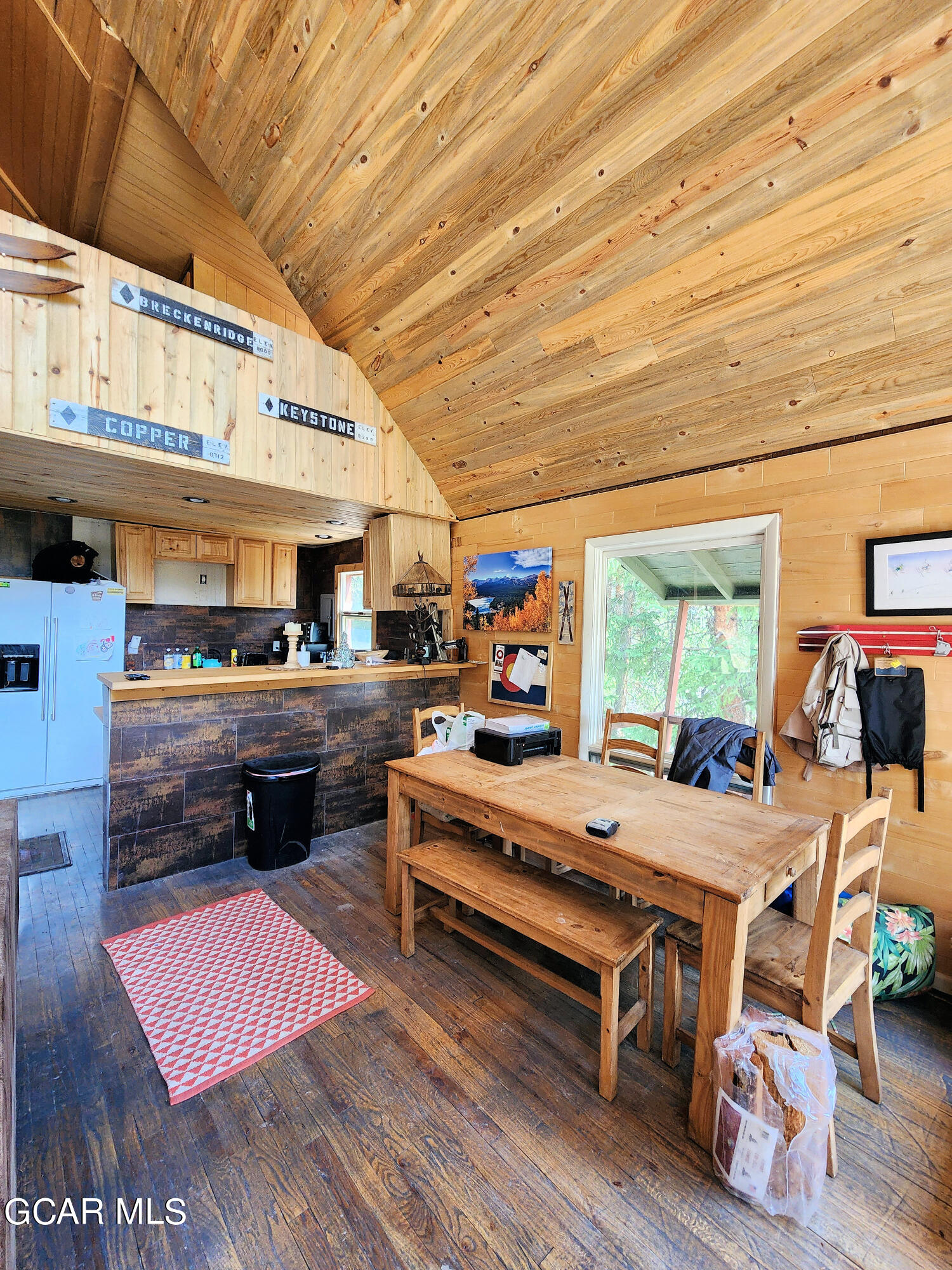 573 97 Circle Breckenridge, CO 80424 - Photo 9 of 40 a room with stainless steel appliances kitchen island granite countertop furniture and a wooden floor