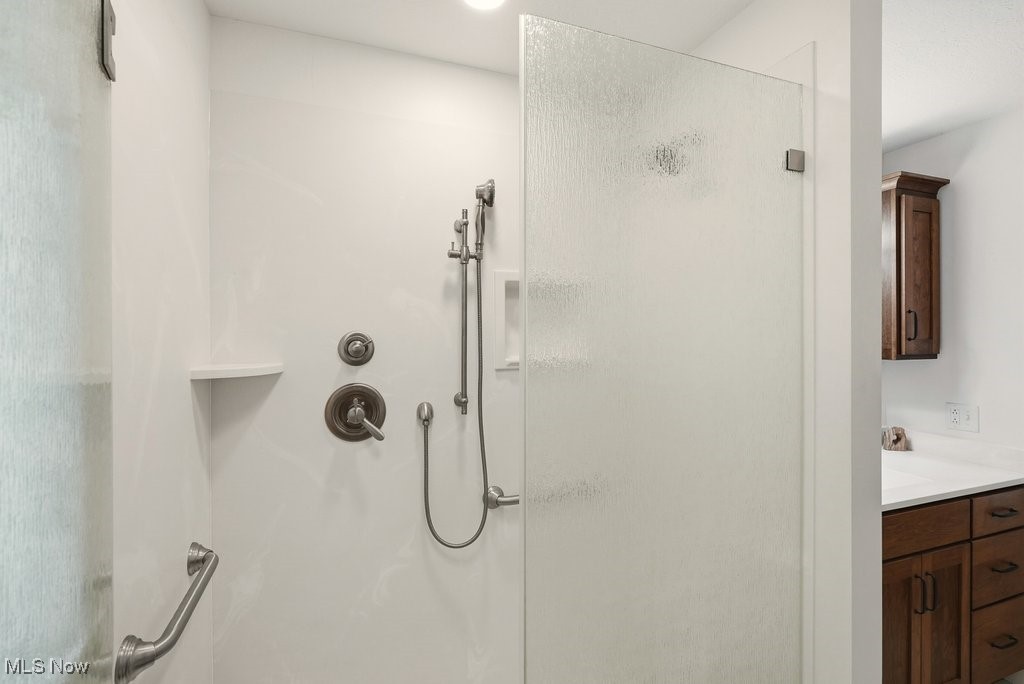 1430 Magnolia Road Southwest Dellroy, OH 44620 - Photo 23 of 50 Walk-in shower with updated fixtures and easy-maintenance design.
