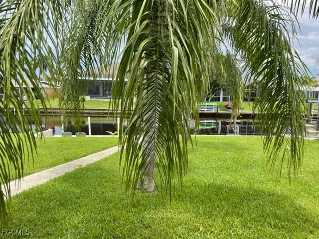 a green field with lots of trees in it