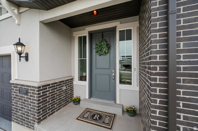3359 Eurasian Crane Road Clinton, UT 84015 - Photo 4 of 71 Property entrance with a porch, stucco siding, and a garage