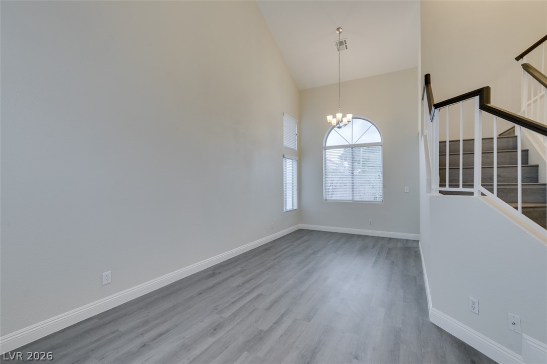 1738 Toltec Circle Henderson, NV 89014 - Photo 45 of 46 Lofty ceilings and a grand arched window illuminate this inviting open-concept living space with sleek flooring.