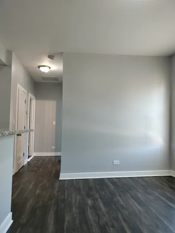 a view of an empty room and wooden floor