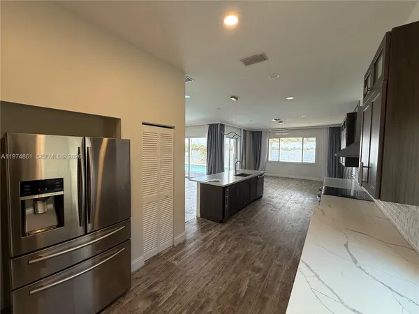 a view of a refrigerator in kitchen and wooden floor