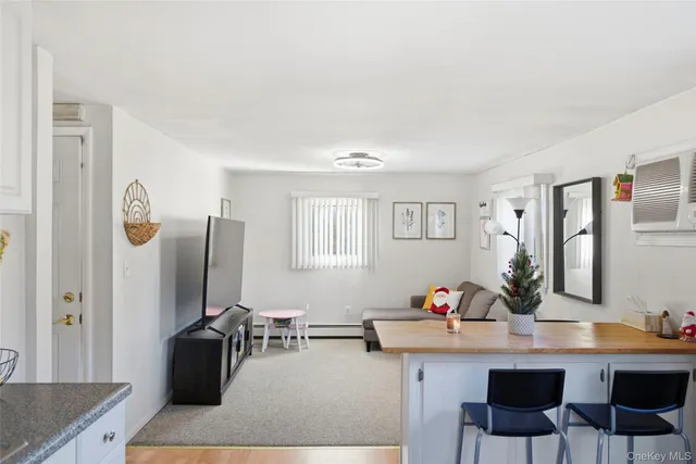 a living room with furniture a desk and chair flat screen tv