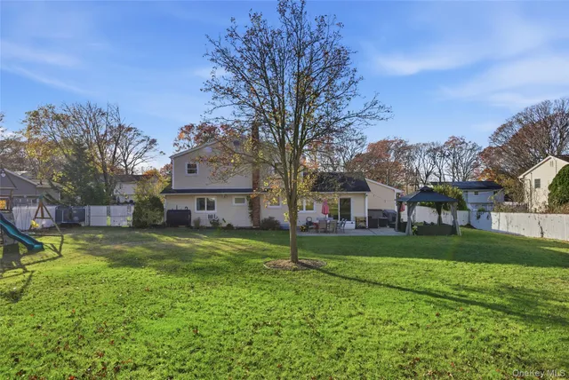 a house view with a sitting space and garden