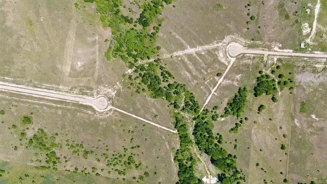 a view of a street with a big yard