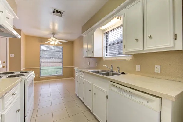 a kitchen with a sink cabinets and window