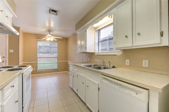 a kitchen with a sink cabinets and window