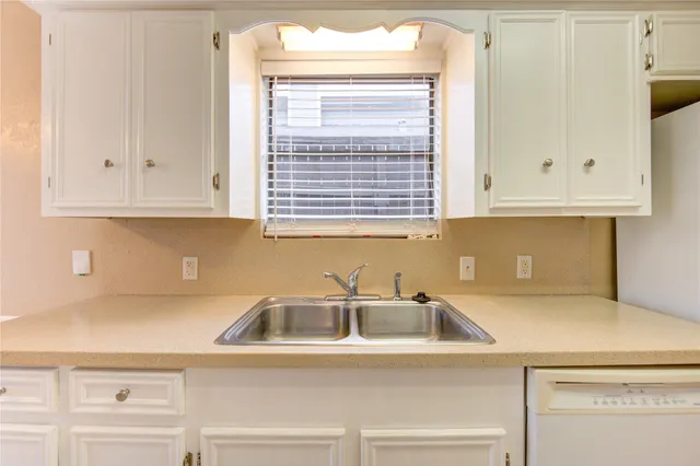 a kitchen with a sink and cabinets