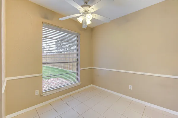 a kitchen with cabinets and wooden floor