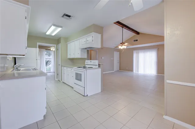 a large kitchen with stainless steel appliances granite countertop a stove and a sink