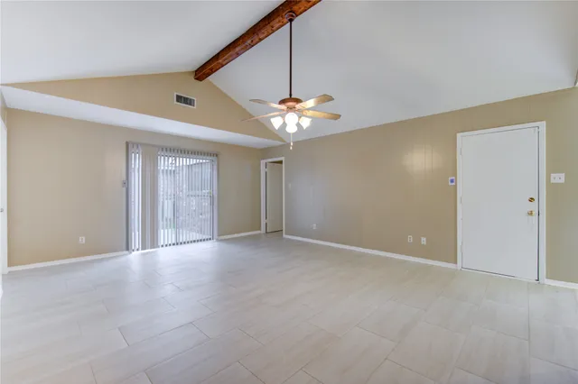 a view of an empty room with a ceiling fan