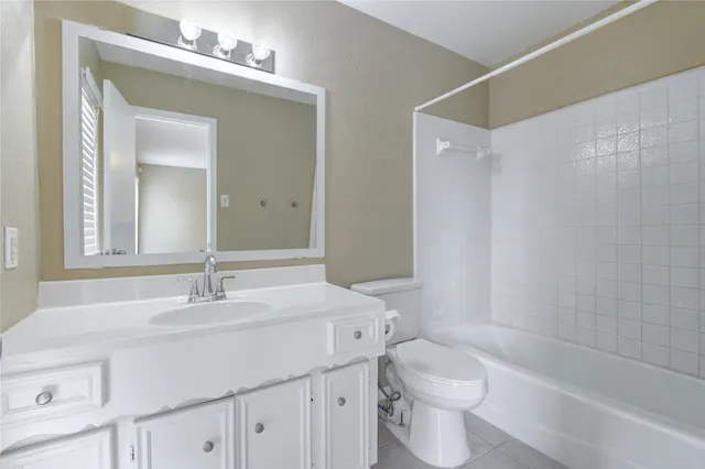 a bathroom with a sink vanity mirror and toilet