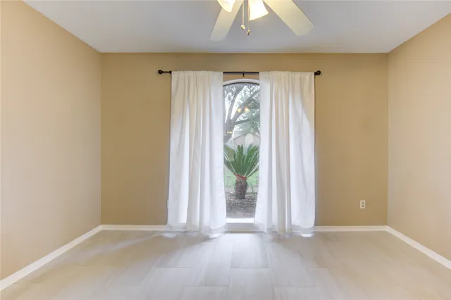 a view of an empty room and a window