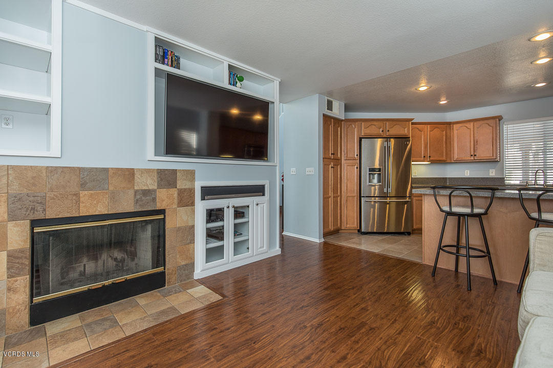 1745 Empty Saddle Road Simi Valley, CA 93063 - Photo 10 of 29 a view of a livingroom with wooden floor and a fireplace