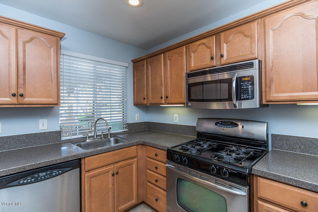 1745 Empty Saddle Road Simi Valley, CA 93063 - Photo 14 of 29 a kitchen with granite countertop wooden cabinets and a stove top oven
