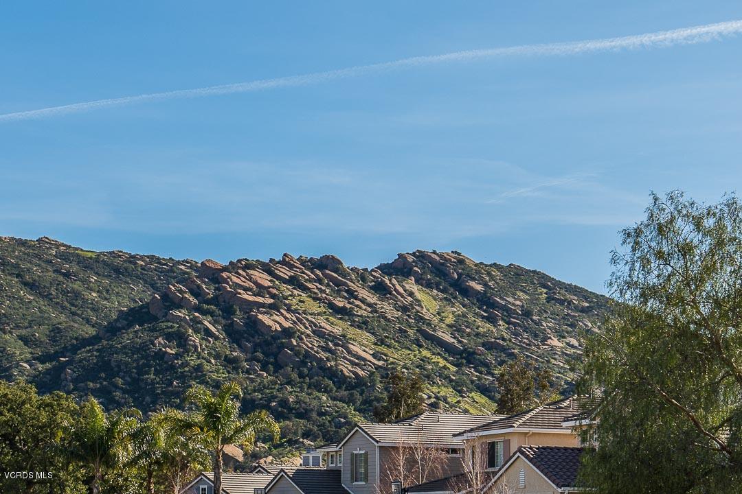 1745 Empty Saddle Road Simi Valley, CA 93063 - Photo 3 of 29 a view of a large building with a mountain in the background