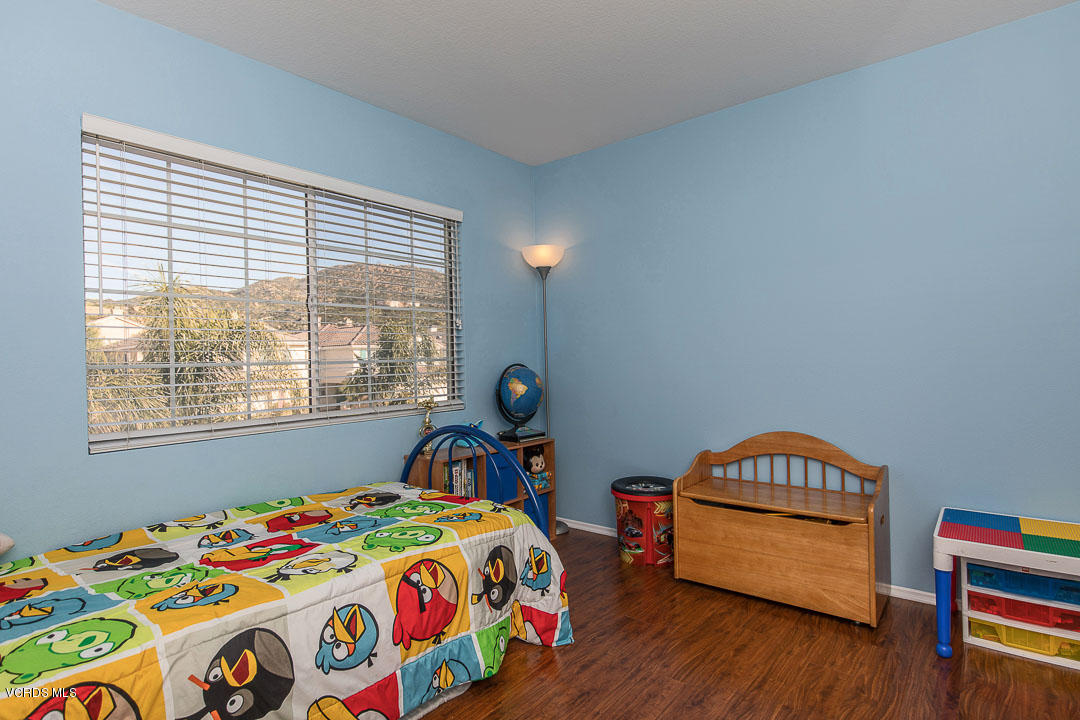 1745 Empty Saddle Road Simi Valley, CA 93063 - Photo 22 of 29 a bedroom with a bed and a window in it