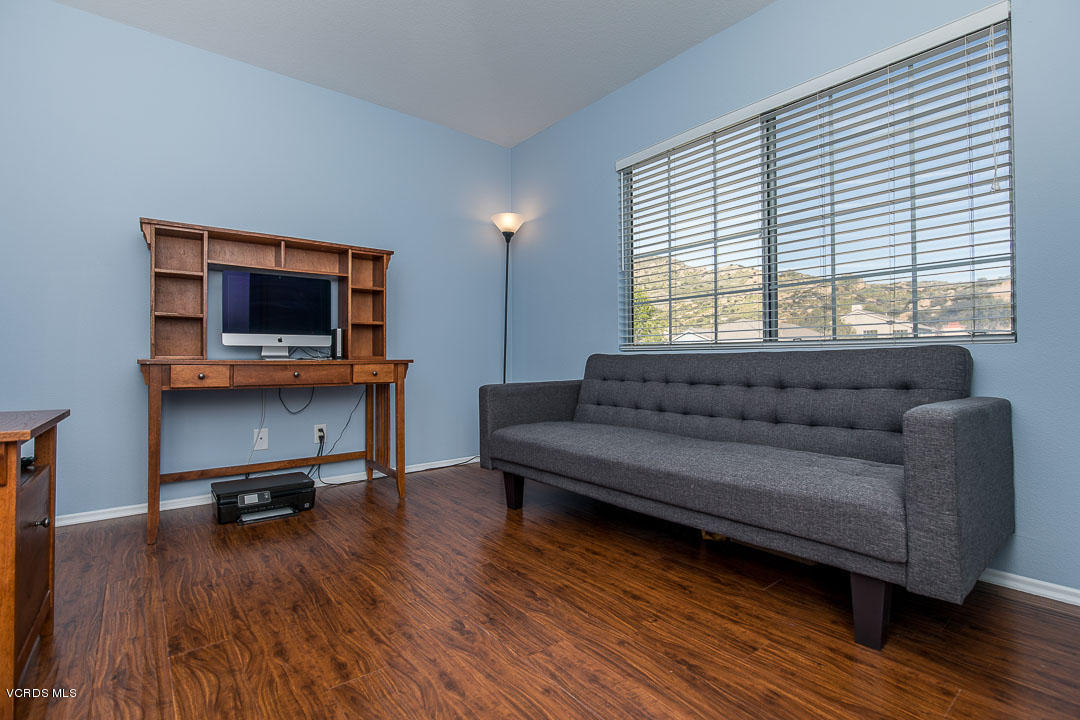 1745 Empty Saddle Road Simi Valley, CA 93063 - Photo 23 of 29 a living room with furniture and a flat screen tv