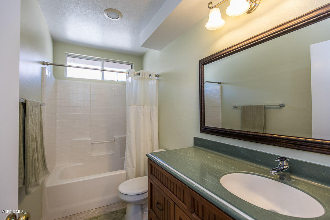 1745 Empty Saddle Road Simi Valley, CA 93063 - Photo 24 of 29 a bathroom with a sink a toilet and shower a mirror