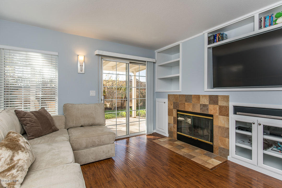 1745 Empty Saddle Road Simi Valley, CA 93063 - Photo 8 of 29 a living room with furniture a flat screen tv and a fireplace