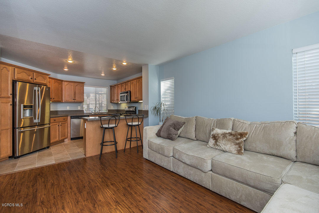 1745 Empty Saddle Road Simi Valley, CA 93063 - Photo 9 of 29 a living room with stainless steel appliances furniture and a kitchen view