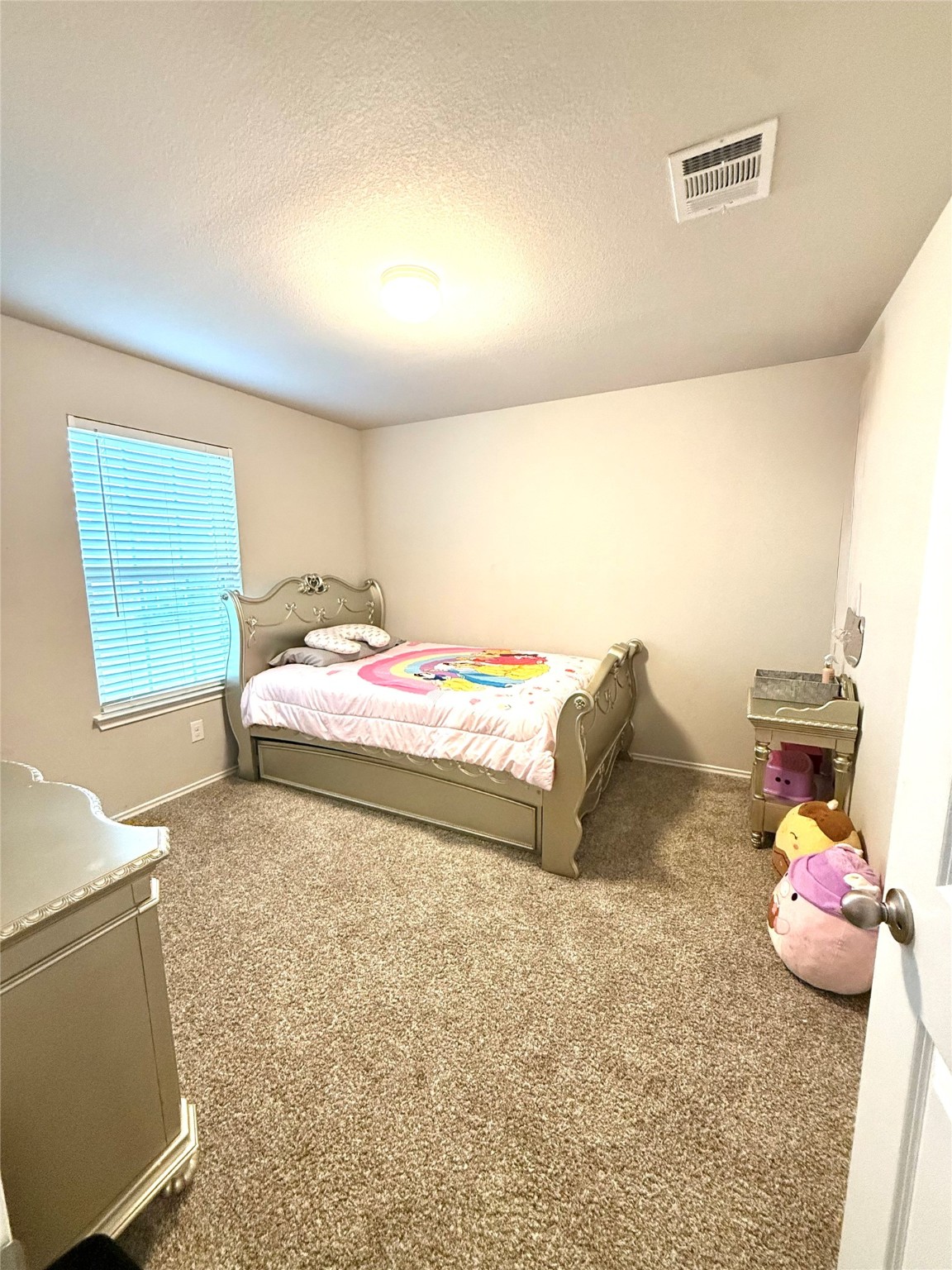 15418 Rancho Plata Drive Channelview, TX 77530 - Photo 12 of 20 a bedroom with a bed and a window