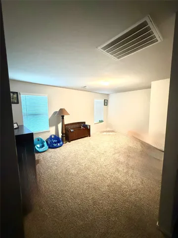 a big room with closet and wooden floor