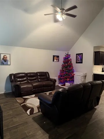 a living room with furniture and a chandelier
