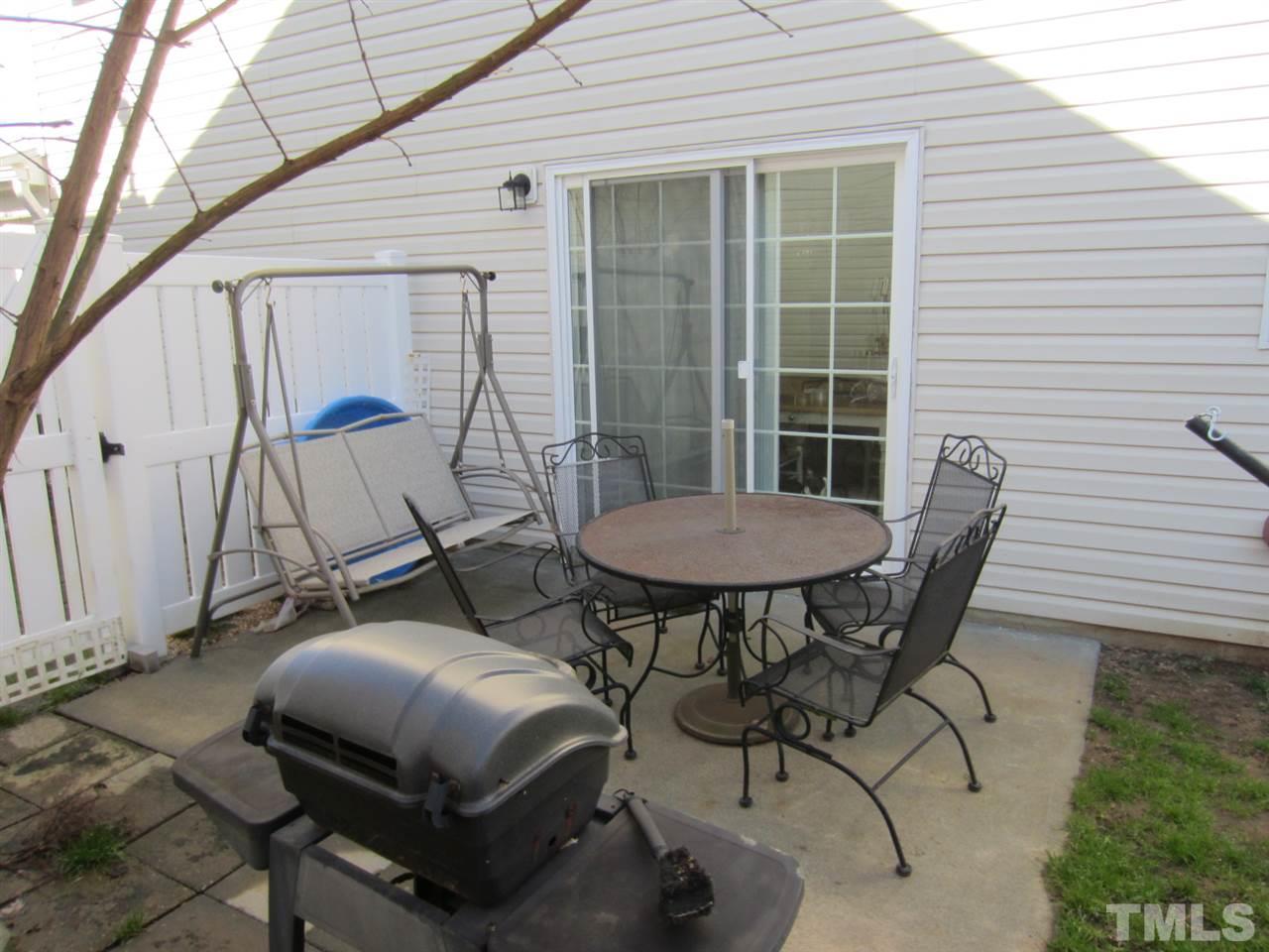 9901 Treymore Drive Raleigh, NC 27617 - Photo 17 of 25 a backyard of a house with table and chairs